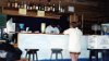 Brenda at the bar at the dive shop and bar & grille after first scuba dive at the Discover Scuba Experience - Roatan.