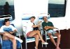 Day at sea. Sharon & Brenda watch Mark nap (Dick taking picture in reflection).