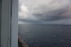 From our balcony, morning storms in the distance as we approach George Town, Grand Cayman.