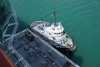 Tug boat in Miami holding a fueling barge along side.