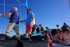 Guys helping raise the main sail on the Golden Eagle Catamaran, St. Maarten