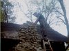 Oliver putting up the chimney with native rock